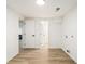 Empty laundry room with vinyl flooring and a white ceiling with two white doors at 3388 Hyland Dr, Decatur, GA 30032