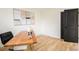 Bright home office space with natural light, a stylish wood desk, and a black door at 3388 Hyland Dr, Decatur, GA 30032