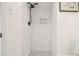 White tiled shower with mosaic base and black shower head fixtures at 3388 Hyland Dr, Decatur, GA 30032