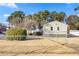 Fenced backyard with trees, grass, and an outbuilding, offering privacy and space at 1035 Stonewall Se Dr, Atlanta, GA 30315