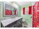 A colorful bathroom with a marble vanity, unique shower curtain, and bright green walls at 1035 Stonewall Se Dr, Atlanta, GA 30315