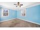 A serene blue bedroom with carpet, a ceiling fan, and two windows for ample light at 1035 Stonewall Se Dr, Atlanta, GA 30315