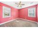 A bright pink bedroom featuring carpeted floors and two windows offering natural light at 1035 Stonewall Se Dr, Atlanta, GA 30315