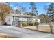 Charming single-story home featuring a covered front porch, neutral siding, a driveway and a chain link fence at 1035 Stonewall Se Dr, Atlanta, GA 30315