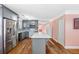 A contemporary kitchen featuring gray cabinets, stainless steel appliances, and a large island at 1035 Stonewall Se Dr, Atlanta, GA 30315