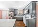 Modern kitchen with gray cabinets, an island, stainless steel appliances, and stylish backsplash at 1035 Stonewall Se Dr, Atlanta, GA 30315