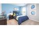 Bedroom with blue walls, carpet, blue and yellow bedding and dinosaur decor at 11903 Aukerman Way, Hampton, GA 30228