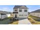 Beautiful two-story home featuring a two-car garage, manicured lawn, and classic architectural details at 11903 Aukerman Way, Hampton, GA 30228