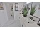 Bright, modern bathroom with marble floors, stylish vanity, and an open doorway at 701 Smith St, Atlanta, GA 30310