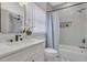 Bathroom featuring a shower-tub combo with modern fixtures, a built-in niche, and a white vanity at 701 Smith St, Atlanta, GA 30310