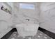 Contemporary bathtub with marble-like walls, modern fixtures, and unique tile flooring at 701 Smith St, Atlanta, GA 30310
