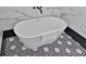 Modern freestanding bathtub with unique mosaic tile flooring and clean, minimalist design at 701 Smith St, Atlanta, GA 30310