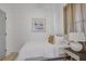 Cozy bedroom featuring a white bedspread, minimalist decor, and natural light from the window at 701 Smith St, Atlanta, GA 30310