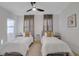 Inviting bedroom with two twin beds, ceiling fan, and modern décor for a comfortable stay at 701 Smith St, Atlanta, GA 30310
