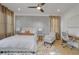 Bright bedroom featuring an electric fireplace, ceiling fan, statement wall, and soft decor at 701 Smith St, Atlanta, GA 30310