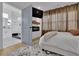 Bedroom with an open bathroom, TV, fireplace, and soft, light-filtering window treatments at 701 Smith St, Atlanta, GA 30310