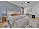 Cozy bedroom with a textured accent wall, plush bedding, and stylish furnishings at 701 Smith St, Atlanta, GA 30310