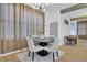 Dining room with hardwood floors, elegant curtains, and a game table in the background at 701 Smith St, Atlanta, GA 30310