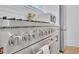 Close-up of the stainless steel gas range, and white countertops with neutral cabinetry at 701 Smith St, Atlanta, GA 30310