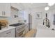 Modern kitchen with white cabinets, stainless steel appliances, and a kitchen island at 701 Smith St, Atlanta, GA 30310