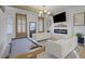 Bright living room featuring modern fireplace, TV, hardwood floors, and game table at 701 Smith St, Atlanta, GA 30310