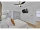 Bright main bedroom featuring a ceiling fan, television, and a private en-suite bathroom at 701 Smith St, Atlanta, GA 30310
