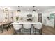 Modern kitchen with white cabinets, quartz countertops, and a spacious island with seating at 1091 Pine St, Conyers, GA 30012