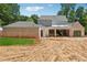 Back exterior of home with large sliding glass doors and unfinished backyard and landscaping at 141 N. Trace, Alpharetta, GA 30009