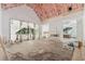 Living room with vaulted ceilings featuring bright sunlight and large windows showing the surrounding backyard at 141 N. Trace, Alpharetta, GA 30009