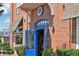 Exterior of Standard Service with blue door and brick facade at 141 N. Trace, Alpharetta, GA 30009
