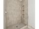 Modern tiled shower with hexagon floor and built-in shelves for added convenience at 141 N. Trace, Alpharetta, GA 30009