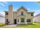 Exterior view of the two-story home with a well-maintained lawn and fenced backyard at 2210 Benidorm Ct, South Fulton, GA 30349