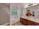 Bright bathroom with double sinks, cherry wood cabinets, garden tub, and a separate shower at 2210 Benidorm Ct, South Fulton, GA 30349