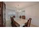 Bright dining room featuring classic wooden furniture and chandelier lighting at 2210 Benidorm Ct, South Fulton, GA 30349