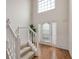 Bright entryway with hardwood floors, a staircase, and a window above the front door at 2210 Benidorm Ct, South Fulton, GA 30349