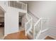Entryway featuring hardwood floors, high ceilings, staircase with white railing and wainscotting at 2210 Benidorm Ct, South Fulton, GA 30349