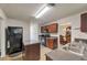 Bright kitchen with stainless steel appliances, including island, and view into breakfast and dining areas at 2210 Benidorm Ct, South Fulton, GA 30349