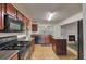 Well-lit kitchen features stainless steel appliances and an island, with a view into the cozy living room at 2210 Benidorm Ct, South Fulton, GA 30349