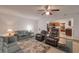 Inviting living room with a ceiling fan, comfortable seating, and view into the kitchen and breakfast area at 2210 Benidorm Ct, South Fulton, GA 30349