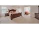 Large main bedroom features neutral paint, a large window and ensuite seating area at 2210 Benidorm Ct, South Fulton, GA 30349