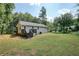 Backyard view of the home with a wooden deck and stairs leading to the yard at 276 Indian Creek Dr, Powder Springs, GA 30127