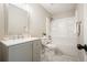 Bathroom featuring a combination tub and shower, updated fixtures, gray paint and a large mirror with vanity lighting at 276 Indian Creek Dr, Powder Springs, GA 30127