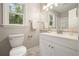 Bathroom with a white vanity, white marble tile, and updated fixtures creating a bright and clean space at 276 Indian Creek Dr, Powder Springs, GA 30127