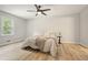 Bright bedroom featuring hardwood floors, a neutral color palette, and a large window offering a green view at 276 Indian Creek Dr, Powder Springs, GA 30127