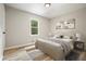 Comfortable bedroom with a queen size bed, wood flooring, a window, and stylish wall art creating a relaxing atmosphere at 276 Indian Creek Dr, Powder Springs, GA 30127