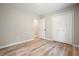 Spare bedroom featuring hardwood floors, a neutral color palette, closet space, and a large window at 276 Indian Creek Dr, Powder Springs, GA 30127