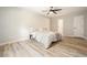 Bright bedroom with hardwood floors, a neutral color palette, closet space, and a window bringing the green view inside at 276 Indian Creek Dr, Powder Springs, GA 30127