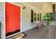 Inviting front porch with comfortable seating, a bright red front door, and a welcome mat at 276 Indian Creek Dr, Powder Springs, GA 30127