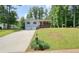 Charming two-story home with a well-manicured front lawn, driveway, and a red front door at 276 Indian Creek Dr, Powder Springs, GA 30127