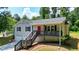 Charming two-story home with a bright red front door and a front porch at 276 Indian Creek Dr, Powder Springs, GA 30127